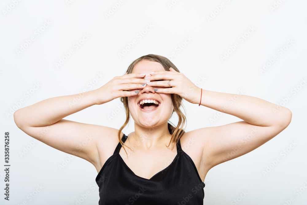 woman closes eyes with her hands