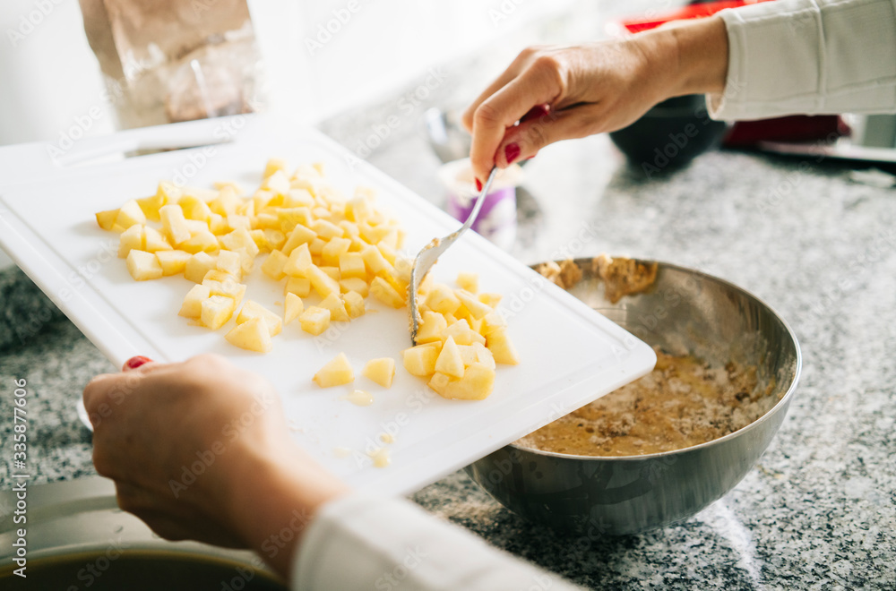 A woman prepares the ingredients to make a sponge cake in her home kitchen A woman prepares the ingredients to make a sponge cake in her home kitchen