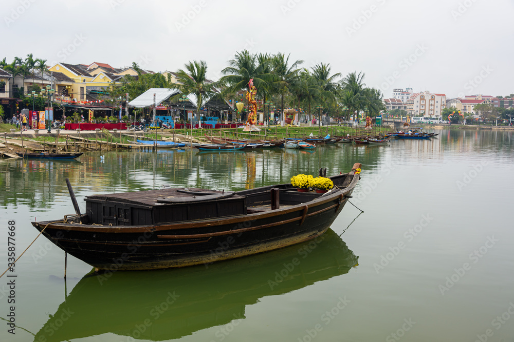A wooden fishing boat on the river in Hoi An, Vietnam A wooden fishing boat on the river in Hoi An, Vietnam