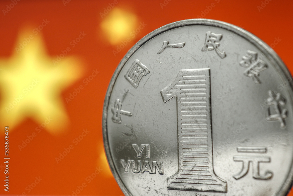 Chinese money. 1 yuan coin on the background of the flag of the