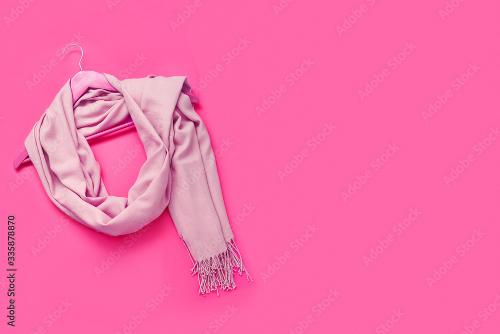Beautiful pink woolen scarf on paper background. Beautiful pink woolen scarf on paper background.