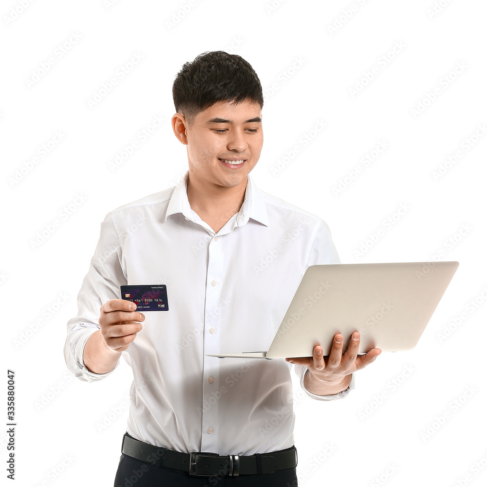 Asian businessman with credit card and laptop on white background Asian businessman with credit card and laptop on white background