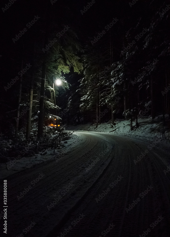 snow covered road in the night snow covered road in the night