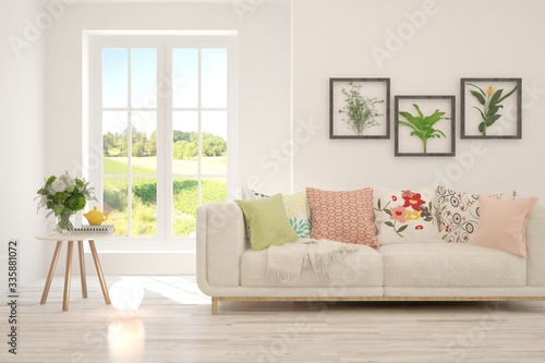 Wallpaper Mural White living room with sofa and summer landscape in window. Scandinavian interior design. 3D illustration Torontodigital.ca