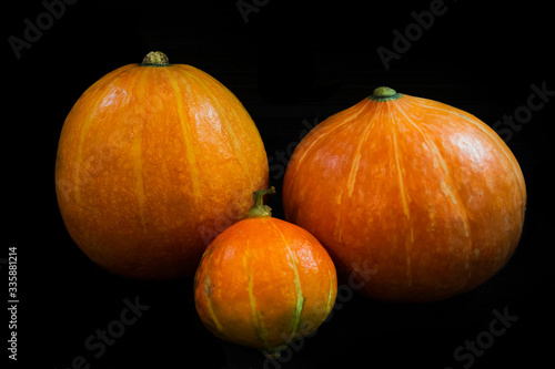 three pumpkin on black background