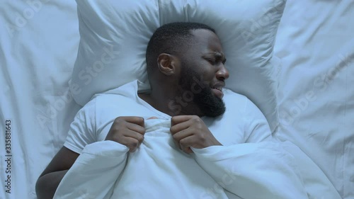 Nervous man seeing bad dream during sleeping, cant waking up, stressful life