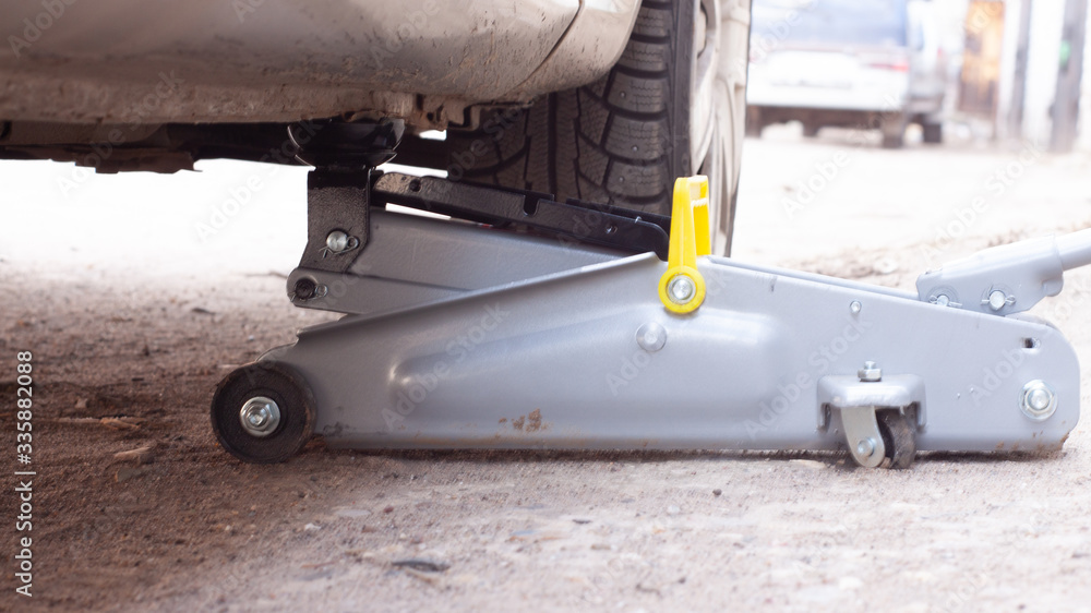replacement of wheels on the car.Lifting the car with a Jack replacement of wheels on the car.Lifting the car with a Jack