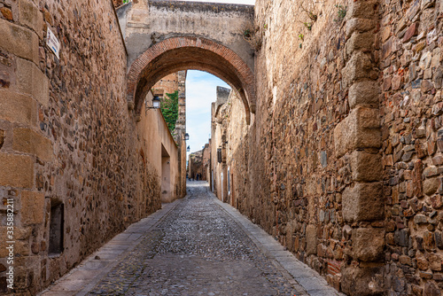 Narrow alley with old stone buildings at Caceres  Extremadura  Spain.