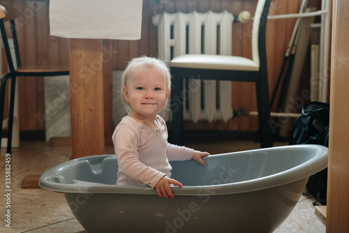 child girl having fun in the bathtub, fantasy ship in the kitchen photo