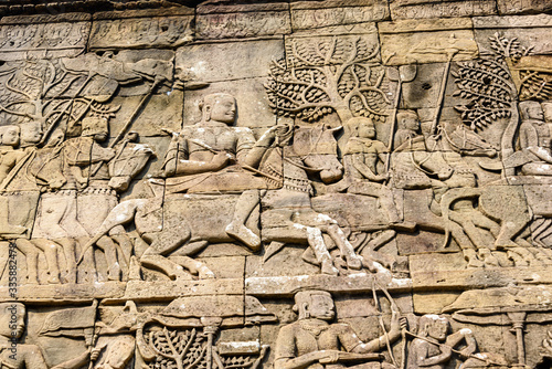 Picturial stories carved into the wall at the Unesco World Heritage site of Ankor Thom, Siem Reap, Cambodia photo