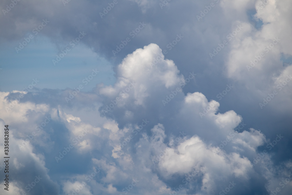 Image of interesting cloud formations with paraglider in summer in the Austrian Alps,