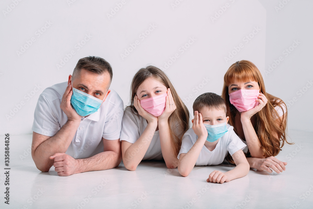 young family in medical masks during home quarantine. young family in medical masks during home quarantine.