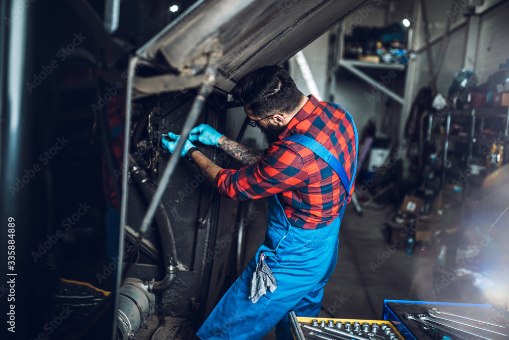 Professional car mechanic working in vehicle repair service. Professional car mechanic working in vehicle repair service.