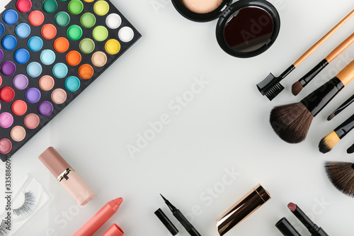 makeup products on white background flat lay with copy space 