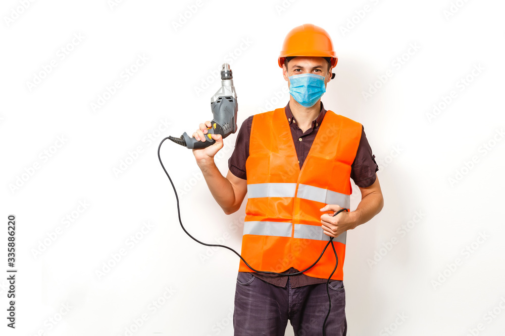 Worker in protective workwear with tools, isolated Worker in protective workwear with tools, isolated