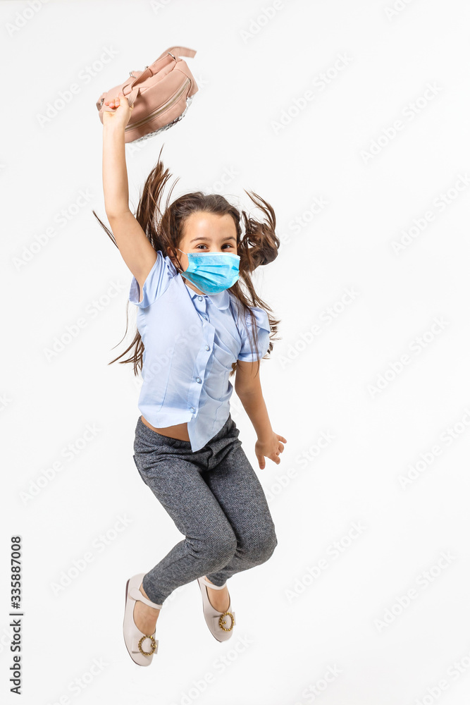 Masked child - protection against influenza virus. Little Caucasian girl wearing mask for protect pm2.5. baby on a gray background with copy space. epidemic, pandemic. Masked child - protection against influenza virus. Little Caucasian girl wearing mask for protect pm2.5. baby on a gray background with copy space. epidemic, pandemic.