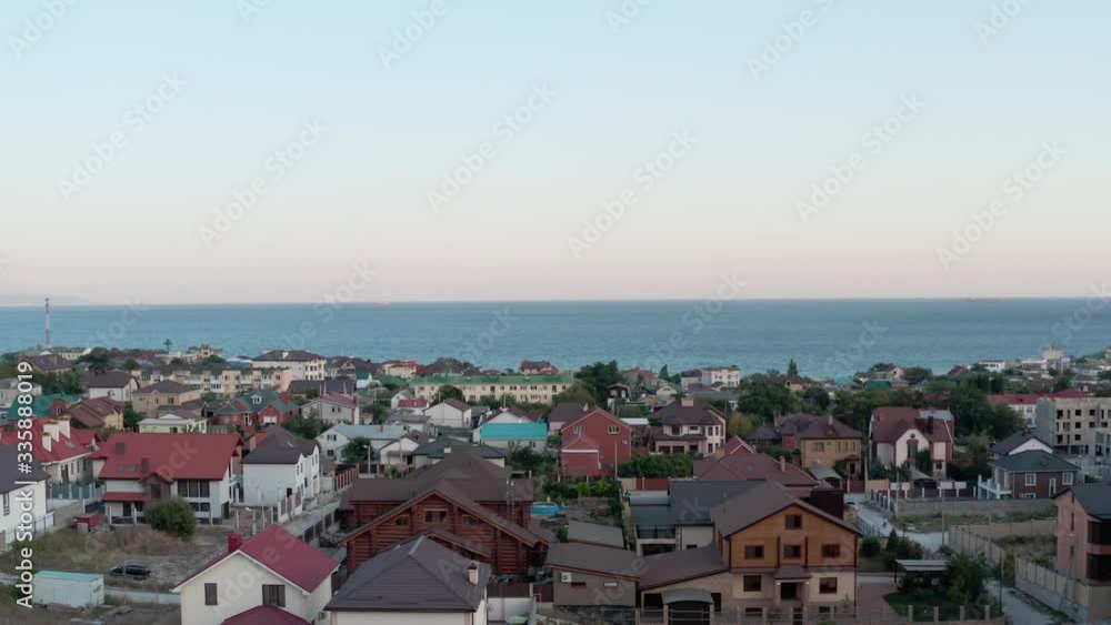 Happy family with a child stand on the exploited roof of their new home and enjoy the ocean Happy family with a child stand on the exploited roof of their new home and enjoy the ocean