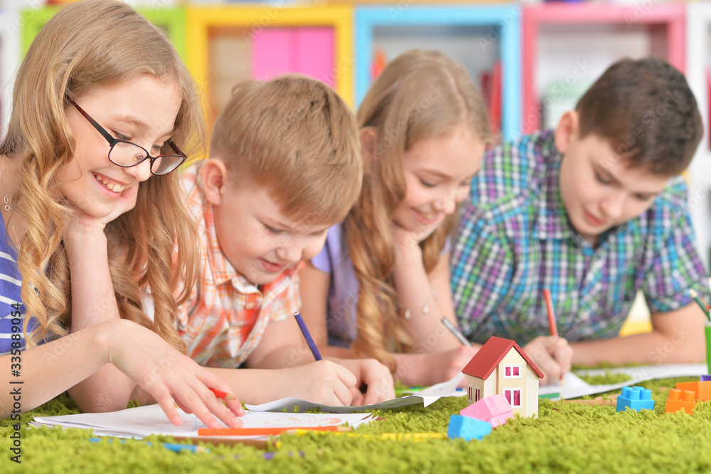 Close up portrait of group of children drawing with pencils Close up portrait of group of children drawing with pencils