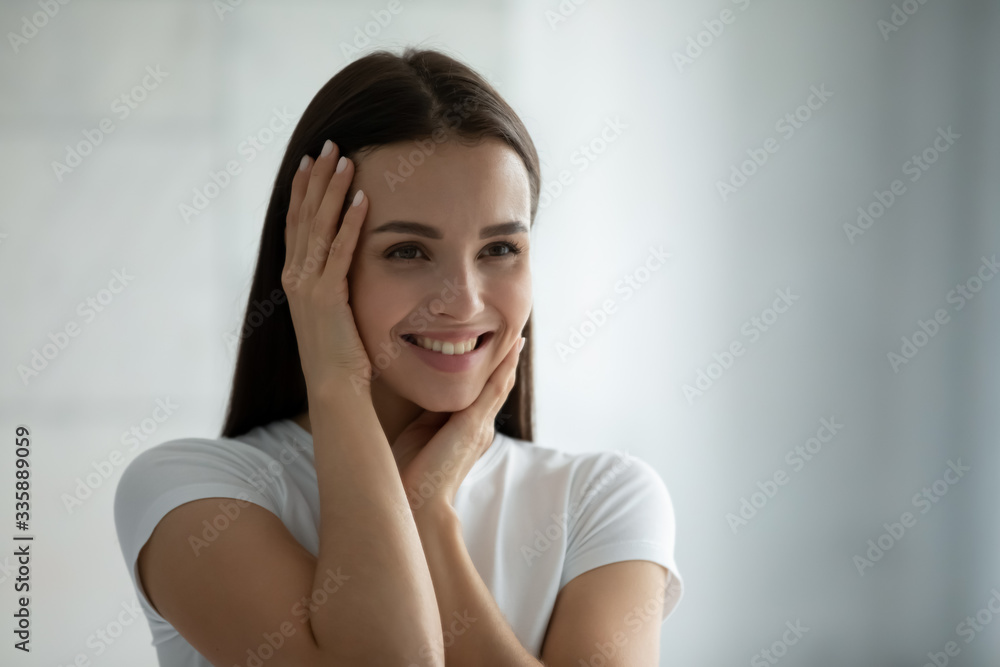 Smiling beautiful millennial girl look in mirror touch healthy growing facial skin, happy pretty young woman satisfied with beauty cosmetology procedures results, clean face after treatment Smiling beautiful millennial girl look in mirror touch healthy growing facial skin, happy pretty young woman satisfied with beauty cosmetology procedures results, clean face after treatment