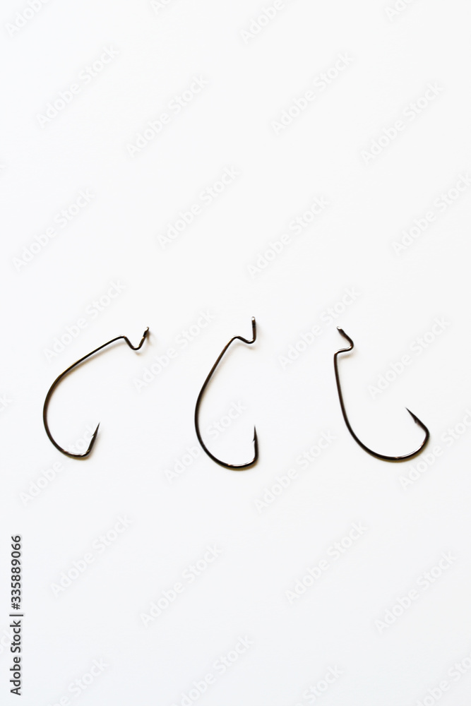 Extremely sharp fishing hook isolated on pure white with reflection Extremely sharp fishing hook isolated on pure white with reflection