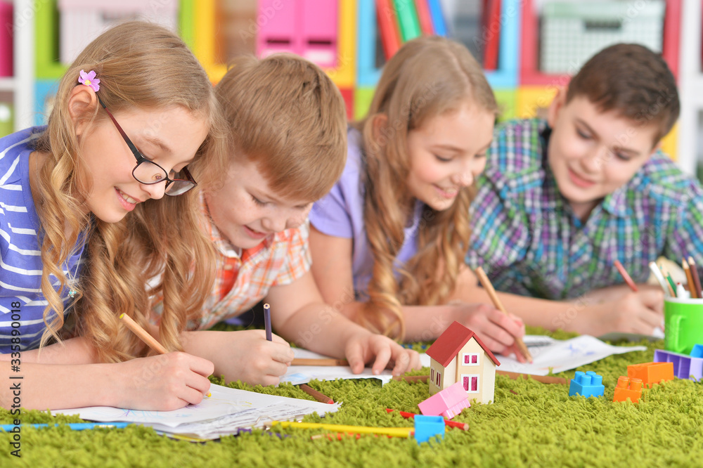 Close up portrait of group of children drawing with pencils Close up portrait of group of children drawing with pencils