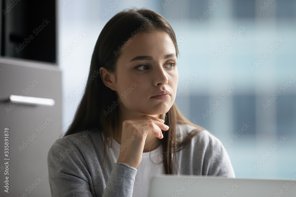Thoughtful millennial girl distracted from computer work look in distance pondering or dreaming, pensive young woman lost in thoughts thinking or visualizing in office, business vision concept Thoughtful millennial girl distracted from computer work look in distance pondering or dreaming, pensive young woman lost in thoughts thinking or visualizing in office, business vision concept