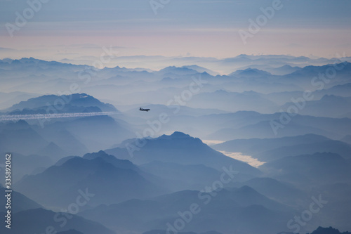 Mountains in foggy haze from an airplane window