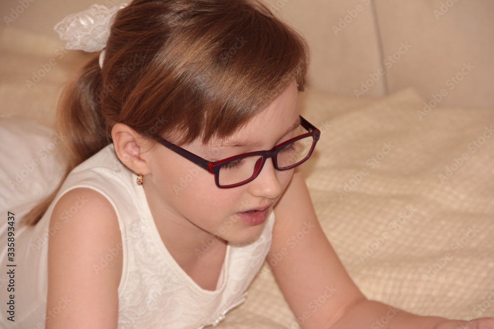Fototapeta premium Beautiful girl in purple glasses. Cute baby
