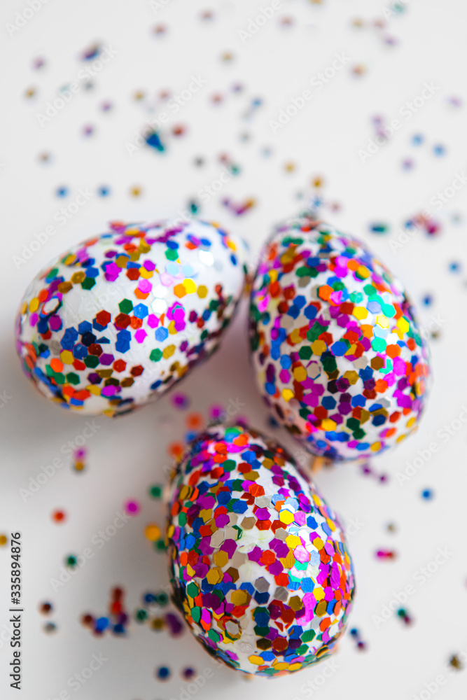 Glitter easter eggs on white background