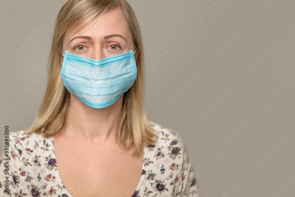 Closeup with a beautiful woman face wearing surgical mask. Closeup with a beautiful woman face wearing surgical mask.