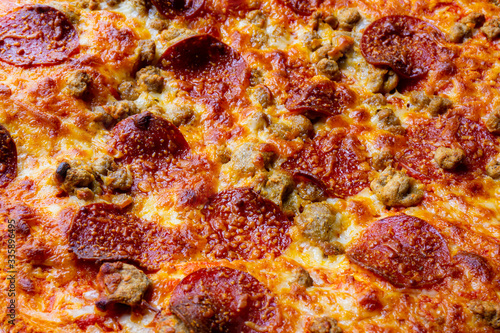 closeup of three meat cheese pizza