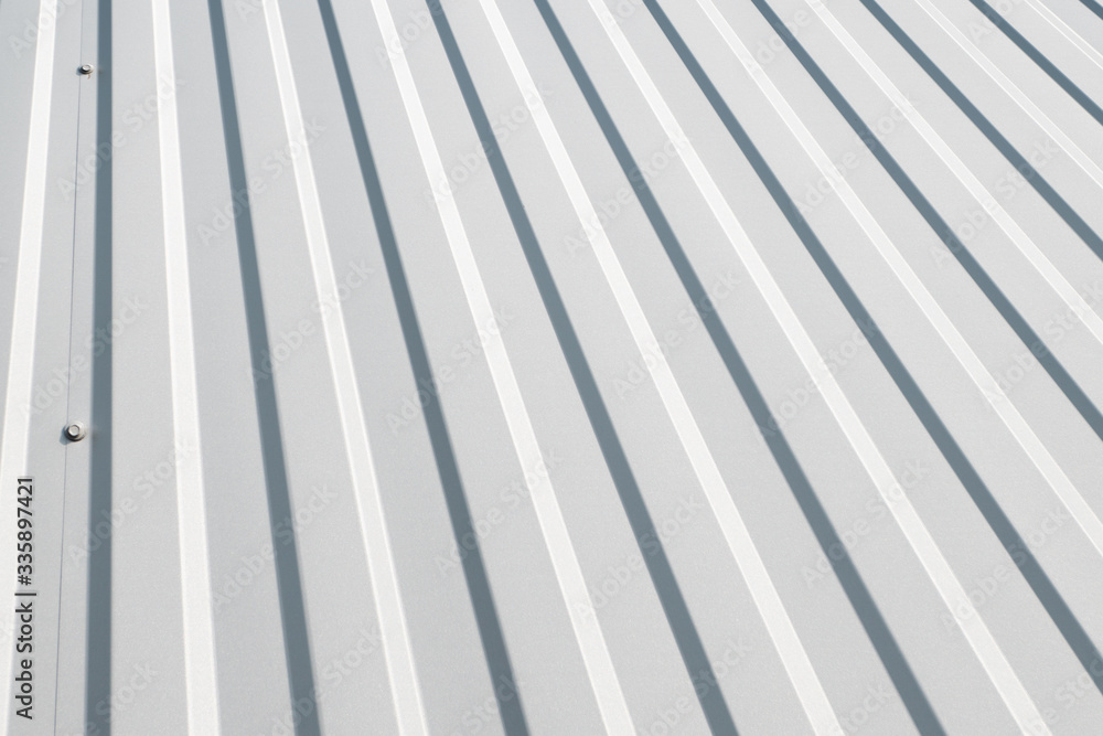 White Corrugated metal sheet surface of the wall. Galvanize steel background. White Corrugated metal sheet surface of the wall. Galvanize steel background.