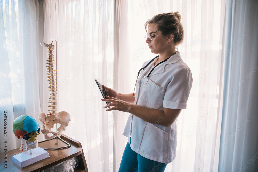 female doctor with artificial bones and tablet female doctor with artificial bones and tablet