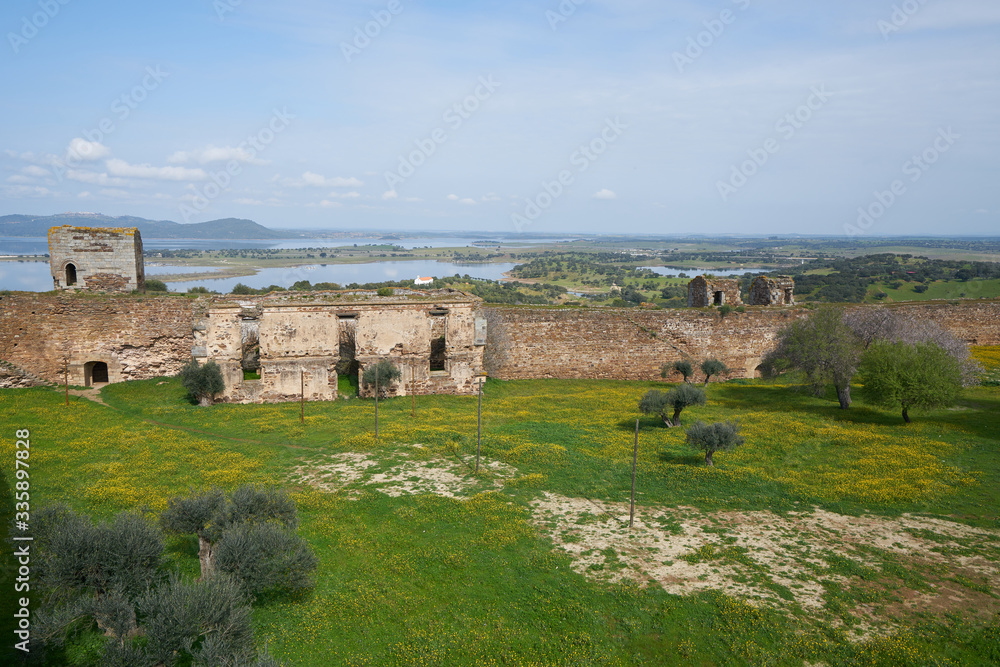 Mourao castle towers and wall historic building with interior garden with alqueva dam reservoir in Alentejo, Portugal