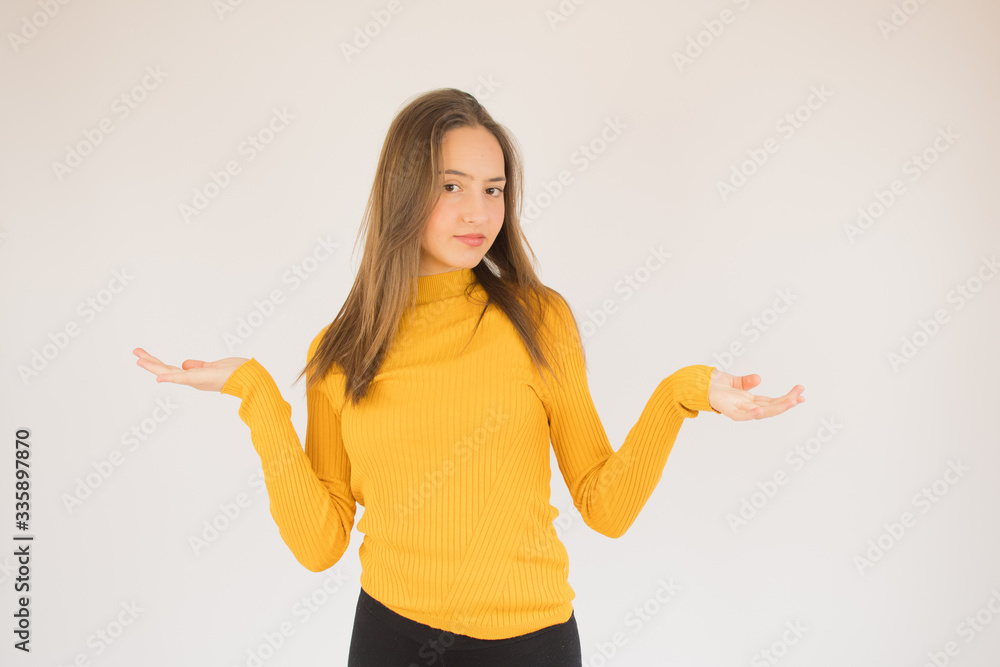 Beautiful young girl with yellow shirt confused Beautiful young girl with yellow shirt confused