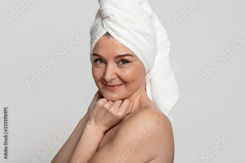 Portrait Of Attractive Nude Middle-Aged Woman With Towel On Head