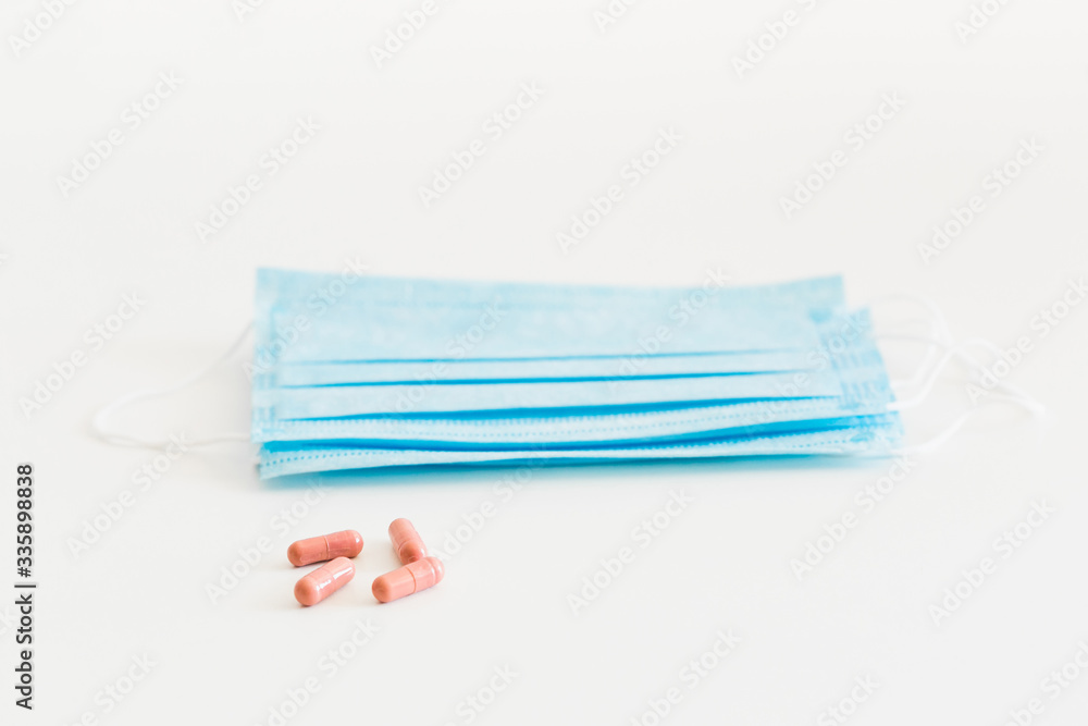 Disposable medical face mask. Prevention of the Covid-19 pandemic virus. Antiviral medical mask for protection from flu diseases. Medical respiratory and tablets Disposable medical face mask. Prevention of the Covid-19 pandemic virus. Antiviral medical mask for protection from flu diseases. Medical respiratory and tablets