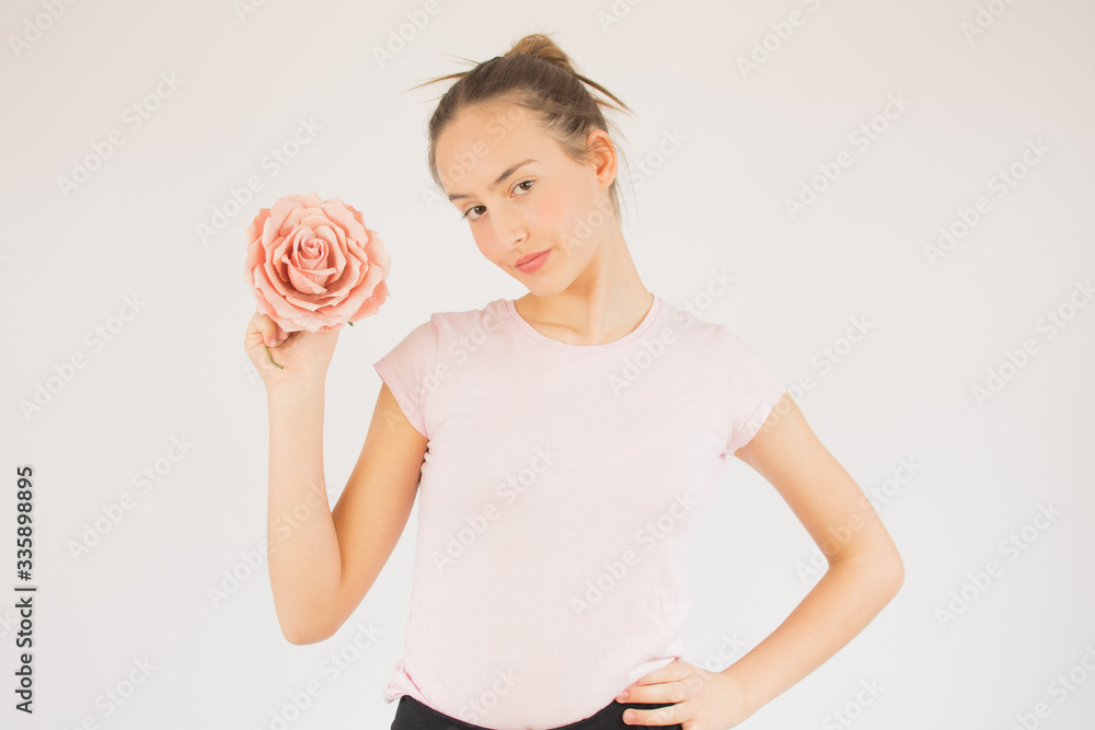 Young beautiful girl with pink shirt and rose Young beautiful girl with pink shirt and rose