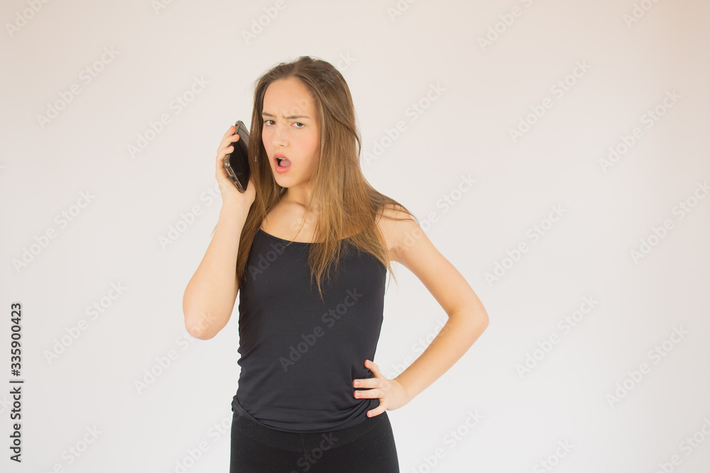 Young beautiful girl with mobile phone surprised Young beautiful girl with mobile phone surprised