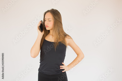 Young beautiful girl with mobile phone surprised