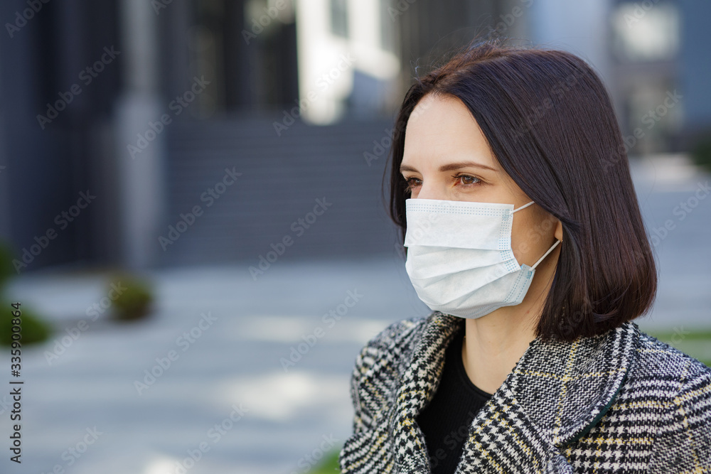 Girl in a medical mask. Stay at home. Pandemic coronavirus. COVID-19. SARS-CoV-2. 2019-nCoV Girl in a medical mask. Stay at home. Pandemic coronavirus. COVID-19. SARS-CoV-2. 2019-nCoV