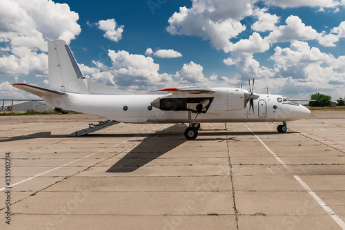 Exterior of AN-26 cargo aircraft parked at the airport photo