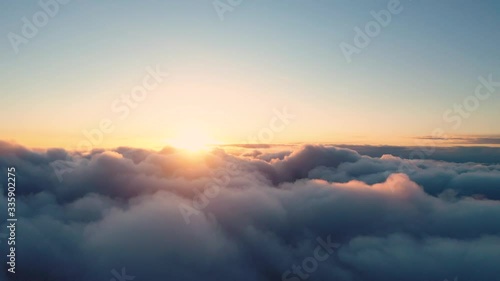 Time lapse beautiful orange sky with clouds background at sunset. Timelapse of white clouds with blue sky. Flight through the moving cloudscape. Texture of clouds. Panoramic view. Clouds in motion	
