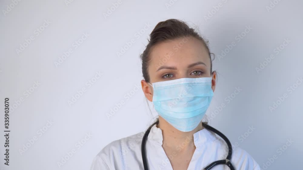 Close up of caucasian doctor with a stethoscope in protective mask. Covid-19 protection Close up of caucasian doctor with a stethoscope in protective mask. Covid-19 protection