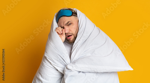 Man in blanket at studio. Hiding from the light © Prostock-studio
