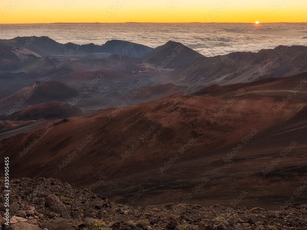 Sun just peaking over the clouds at the top of Maui in Haleakela National Park.