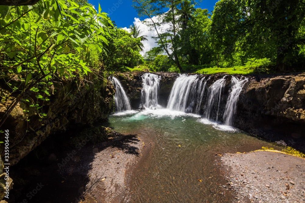 Vibrant Togitogiga falls with swimming hole on Upolu, Samoa Islands Vibrant Togitogiga falls with swimming hole on Upolu, Samoa Islands