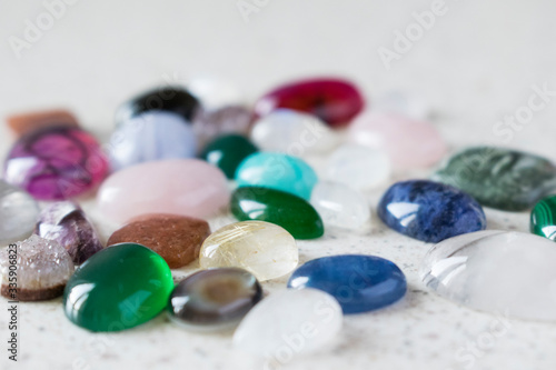 Multicolored polished stones for making jewellery. Colorful cabochons for jeweller.