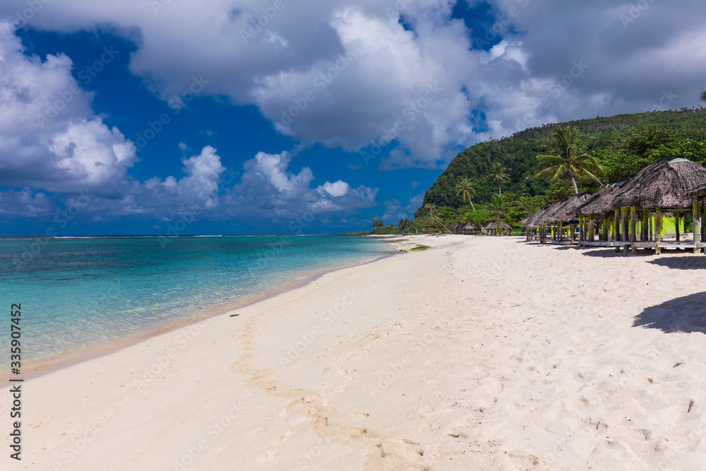 Tropical beach on south side of Samoa Island with coconut palm trees Tropical beach on south side of Samoa Island with coconut palm trees