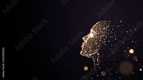 Human face on a black background of gold glowing particles